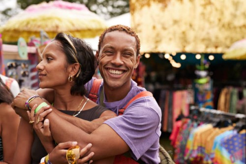 happy young man hugging girlfriend from behind - concert stock pictures, royalty-free photos & images