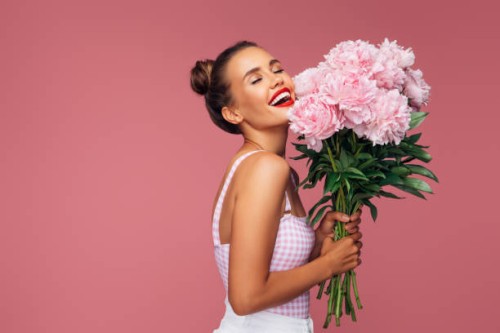 happy young woman holding bouquet of pink flowers - fashion stock pictures, royalty-free photos & images