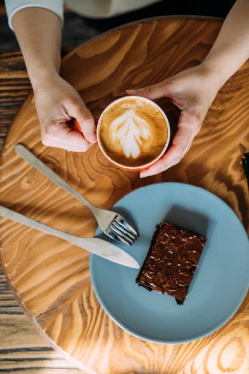 having a little break with a cup of latte and white chocolate brownie - coffee stock pictures, royalty-free photos & images