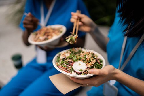 healthcare workers enjoying asian cuisine on outdoor lunch break - junk food stock pictures, royalty-free photos & images