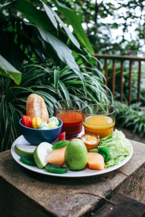 healthy breakfast with tropical fruits, juices and sweets - garden decoration stock pictures, royalty-free photos & images