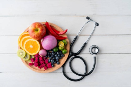 healthy food in heart dish with doctor's stethoscope - food stock pictures, royalty-free photos & images