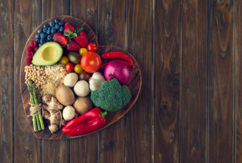 healthy food on a heart shape cutting board - food stock pictures, royalty-free photos & images