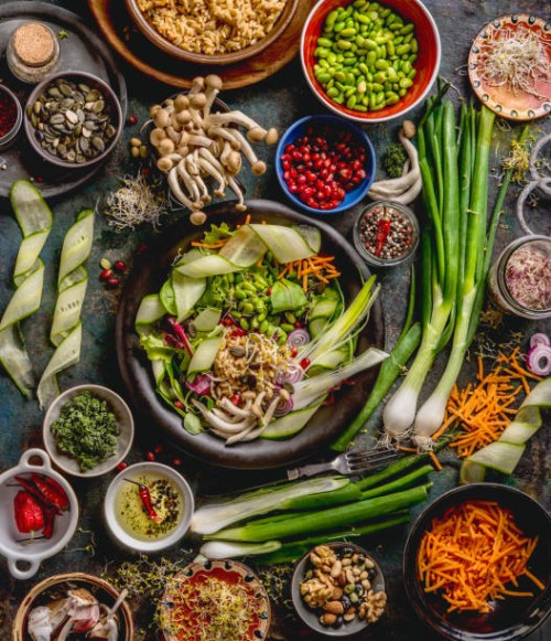 healthy vegan lunch bowl making. detox beautiful buddha bowl with various fresh vegetables, edamame beans, mushrooms, seasoning and pumpkin seeds and nuts topping - food stock pictures, royalty-free photos & images