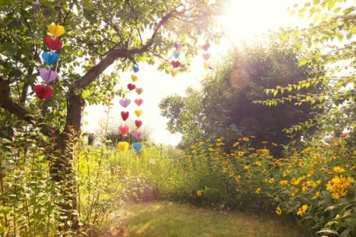 heart-shaped garland made of paper hanging in garden - garden decoration stock pictures, royalty-free photos & images