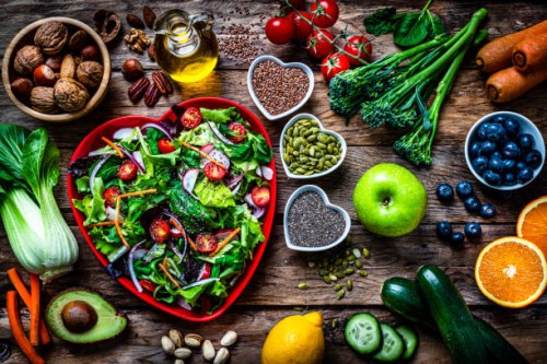 heart shape salad plate on rustic wooden table - food stock pictures, royalty-free photos & images