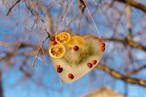 heart shaped suncatcher hanging from a tree branch. - garden decoration stock pictures, royalty-free photos & images