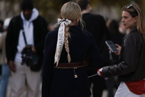 Helena Bordon is seen wearing a blue blazer with a brown belt and a gold narrow belt by Chanel, plus a white hairband by Chanel with a bow in her...