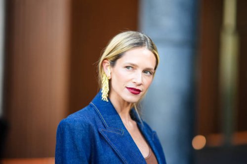 Helena Bordon wears a brown / orange top, a blue denim jacket, gold earrings, outside Zimmermann, during the Womenswear Fall/Winter 2024/2025 as part...