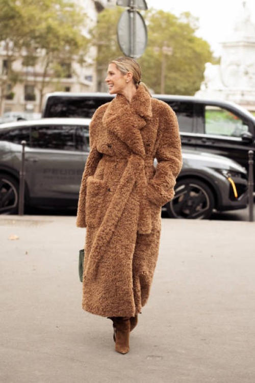 Helena Bordon wears brown belted teddy bear coat, brown boots and olive green bag outside the Stella McCartney show during Womenswear Spring/Summer...