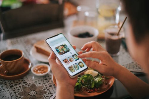 high angle view asian chinese woman's hand on mobile app for online food delivery during breakfast time - food stock pictures, royalty-free photos & images