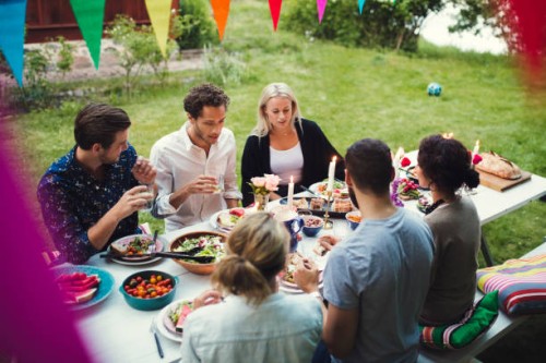 high angle view of friends enjoying dinner at garden party - garden decoration stock pictures, royalty-free photos & images