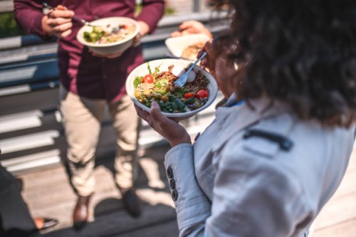 high angle view of senior female enjoying lunch outdoors - junk food stock pictures, royalty-free photos & images