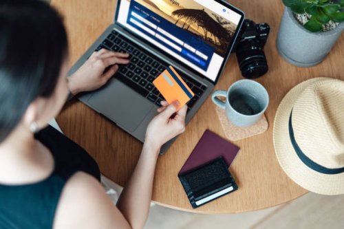 high angle view of young woman booking flight tickets online using laptop - travel stock pictures, royalty-free photos & images