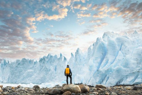 hiker admiring the perito moreno glacier at sunset, argentina - travel stock pictures, royalty-free photos & images