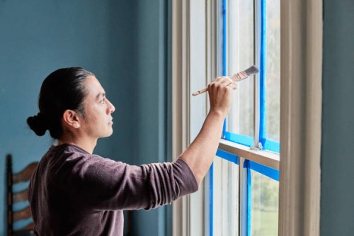 hispanic male painting windows. - home decoration stock pictures, royalty-free photos & images