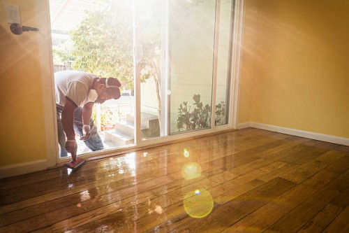 hispanic man refinishing floors in new house - home decoration stock pictures, royalty-free photos & images