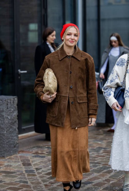 Hollie Mercedes Peters wears red head scarf, brown suede skirt, jacket, beige Bottega Veneta bag outside Munthe during the Copenhagen Fashion Week...