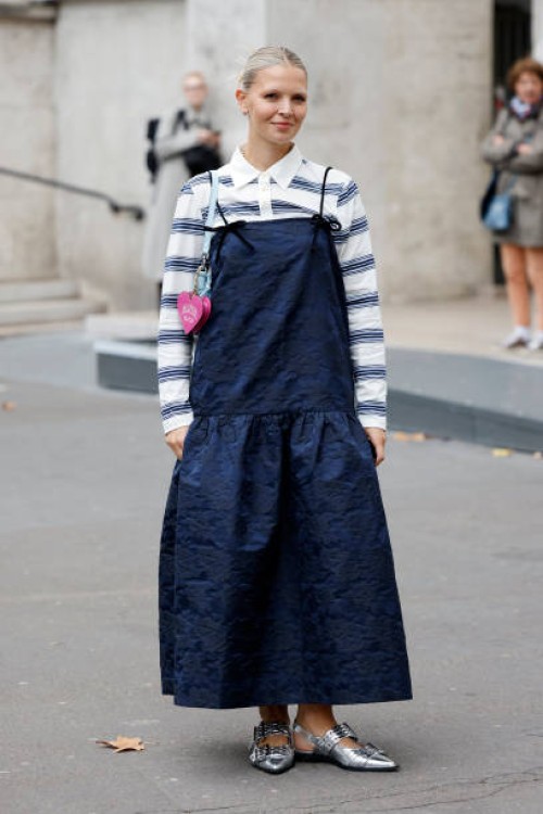 Hollie Mercedes Peters wears white and blue striped polo neck top, blue Ganni maxi dress with matching bomber jacket, light blue Ganni bag, silver...