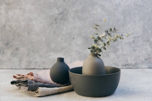 home decor - neutral coloured vases and dish-ware and linen napkin in nordic style against grey wall. - home decoration stockfoto's en -beelden