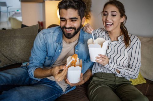 home delivery. couple relaxing at home and eating pasta - junk food stock pictures, royalty-free photos & images