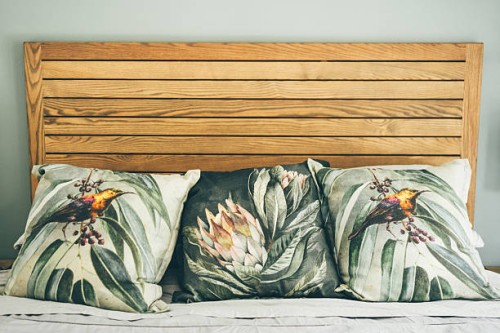 home interior. bed with colored cushions. - home decoration stock pictures, royalty-free photos & images