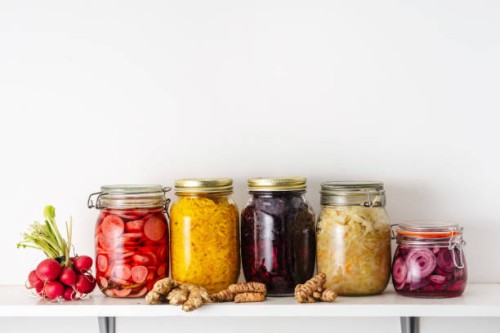 homemade pickled vegetables in jars on shelf at home - food stock pictures, royalty-free photos & images
