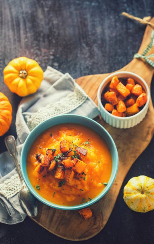 homemade pumpkin cream soup with baked pumpkin pieces in a bowl - food stock pictures, royalty-free photos & images