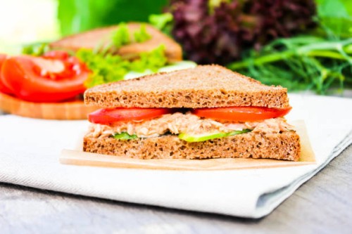 homemade sandwich with rye bread, canned tuna fish, fresh cucumbers and tomatoes, selective focus. picnic food. - junk food stock pictures, royalty-free photos & images