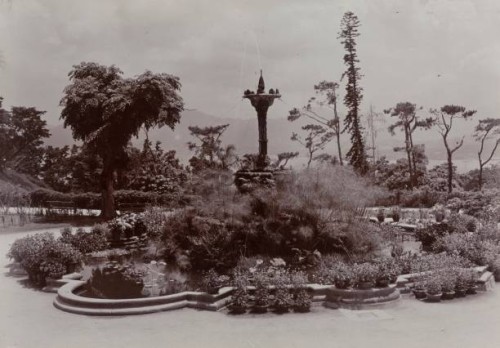 Hong KongChina, A water fountain surrounded by foliage forms the centrepiece of an ornamental pond in Hong Kong's Botanical Gardens.Original...