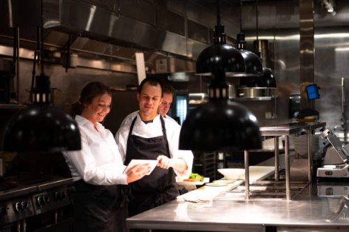 hospitality team discussing bookings on a tablet - food stock pictures, royalty-free photos & images