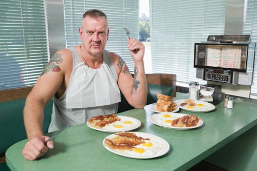 hostile man with plates of fried food - junk food stock pictures, royalty-free photos & images