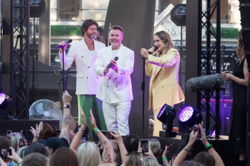 Howard Donald, Gary Barlow and Mark Owen from Take That perform on stage during the world premiere of 'Greatest Days', the cinematic adaptation of...