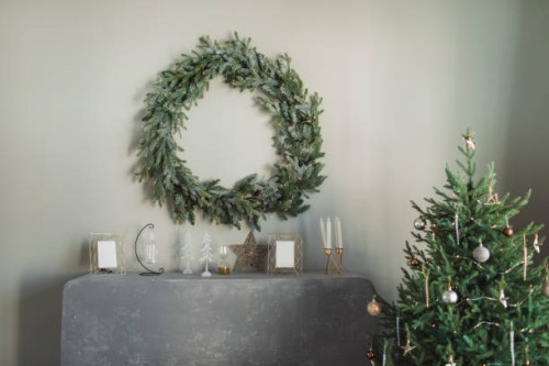 ð¡hristmas wreath in minimal style hanging on gray wall. - home decoration stock pictures, royalty-free photos & images