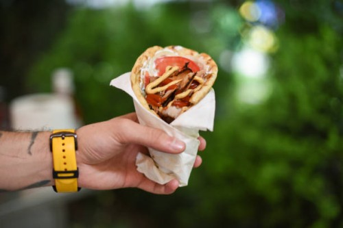 human hand holding deletions gyro pita - junk food stock pictures, royalty-free photos & images