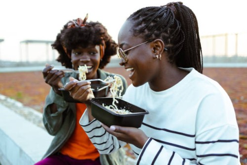 hungry female friends - junk food stock pictures, royalty-free photos & images