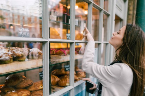 hungry woman at the bakery - junk food stock pictures, royalty-free photos & images