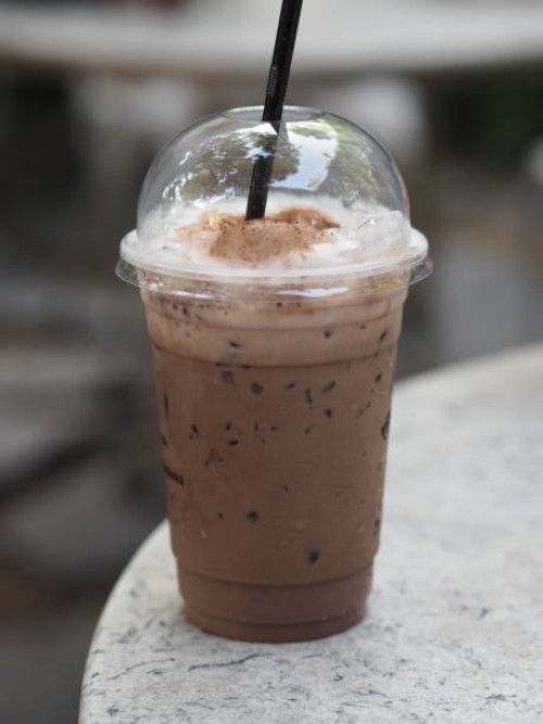 ice coffee in clear plastic cup - junk food stock pictures, royalty-free photos & images