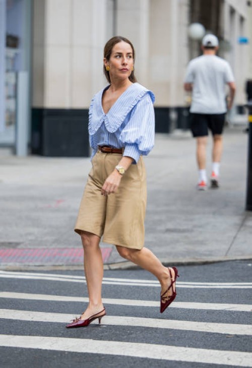 Idalia Salsamendi wears beige shorts, blue white striped blouse, brown belt, brown heels outside New York Fashion Week on September 07, 2024 in New...