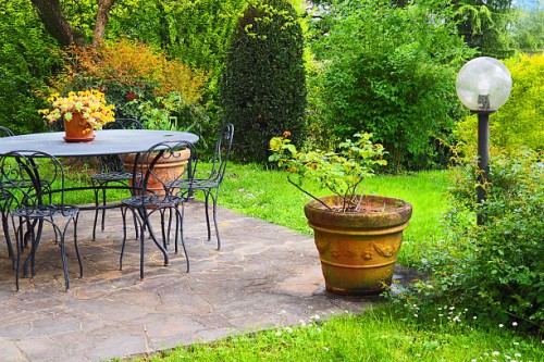 idyllic garden patio, table and chairs, flower pots - garden decoration stock pictures, royalty-free photos & images