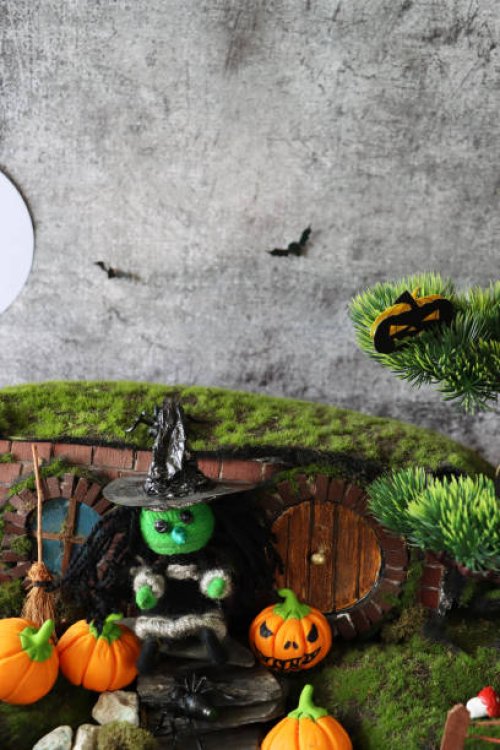 image of witch's house and garden night scene, string witch stood beside broom on slate paddle stone steps, orange fondant icing pumpkin jack o'lanterns, artificial grass - garden decoration stock pictures, royalty-free photo