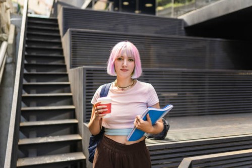image of young woman with colorful hair on university campus and holding sustainable coffee cup - fashion stock pictures, royalty-free photos & images