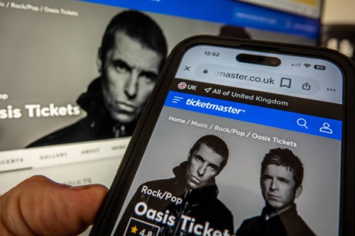 In this photo illustration a laptop and a smart phone displays the Ticketmaster website on September 8, 2024 in Bath, England. The UK's Competition...