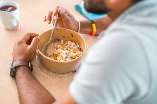 indian male eating take out in corporate office - junk food stock pictures, royalty-free photos & images