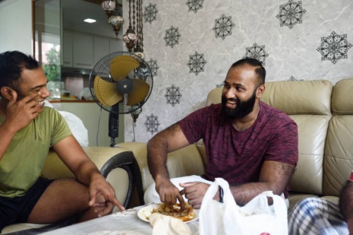 indian man laughing with brother - junk food stock pictures, royalty-free photos & images