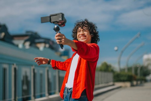influencer asian malay generation z young man vlogging in kuala lumpur city street sidewalk looking at camera - fashion stock pictures, royalty-free photos & images