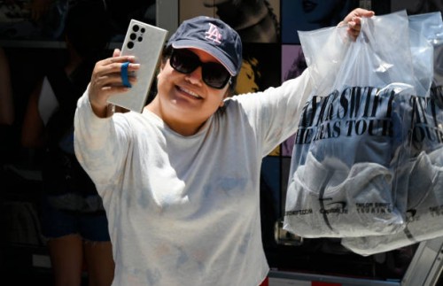 Inglewood, CA Ale Ramirez takes a proud selfie of her Taylor Swift merchandise at SoFi Stadium in Inglewood on Wednesday, August 2, 2023. The Eras...