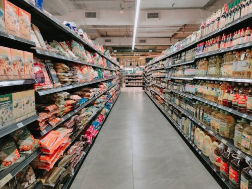 interior of supermarket full of grocery items in rows with shelf displayed - food stock pictures, royalty-free photos & images