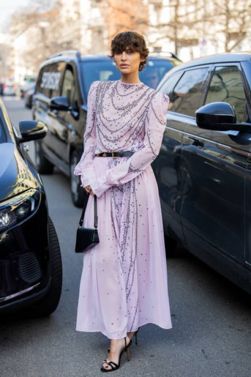 Irina Kro Eicke wears pink dress with belt, bag outside Genny during the Milan Fashion Week Womenswear Fall/Winter 2025/2026 on February 27, 2025 in...