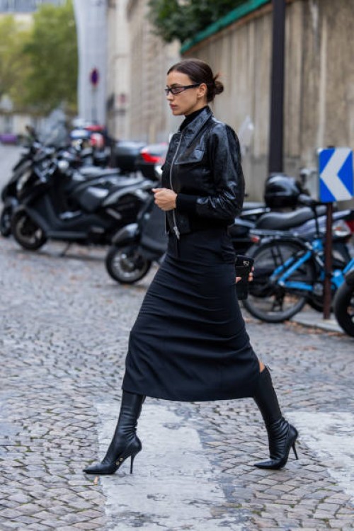 Irina Shayk is seen wearing black vinyl jacket, skirt, boots, sunglasses during a street style shoot as part of Paris Fashion Week on September 27,...